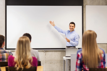 group of students and smiling teacher with notepad