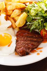 steak with eggs and vegetables