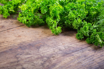 Parsley and dill on wooden table