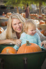 Young Mother and Daughter Enjoys the Pumpkin Patch