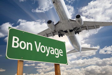 Bon Voyage Green Road Sign and Airplane Above
