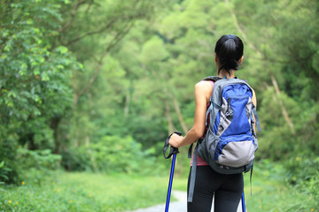 young woman hiker enjoy the view on forest trail