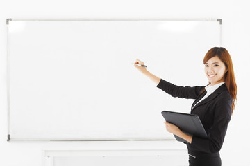asian smiling business woman teaching with a white board
