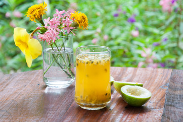 Fresh passion fruit juice with flower garden background