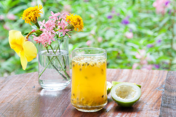 Fresh passion fruit juice with flower garden background