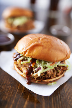 barbecue pulled pork sandwiches with cole slaw on wood table