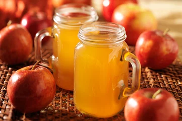 Poster mason jars filled with hot apple cider © Joshua Resnick
