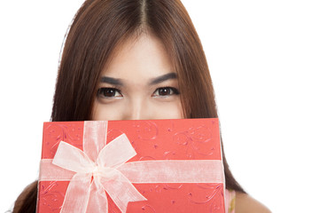 Beautiful Asian woman smile behind red gift box