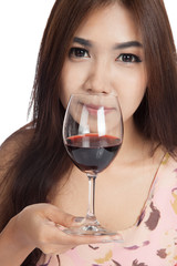 Beautiful Asian woman smell red wine