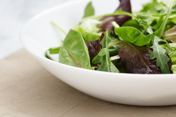 mesclun mix salad in white bowl