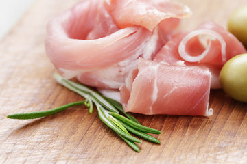 dried jamon slices on wood table