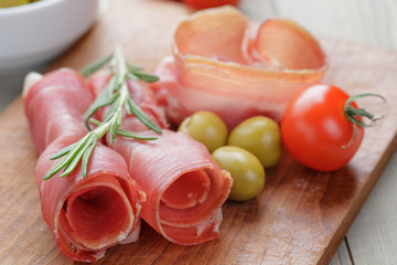 dried jamon slices on wood table