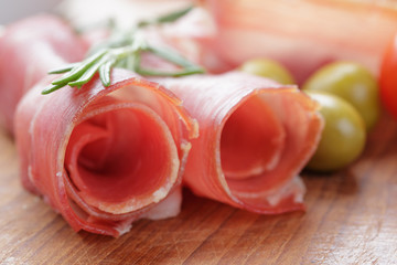 dried jamon slices on wood table