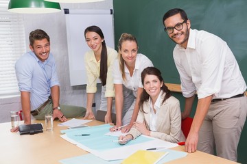 Team of architects studying blueprints during a meeting
