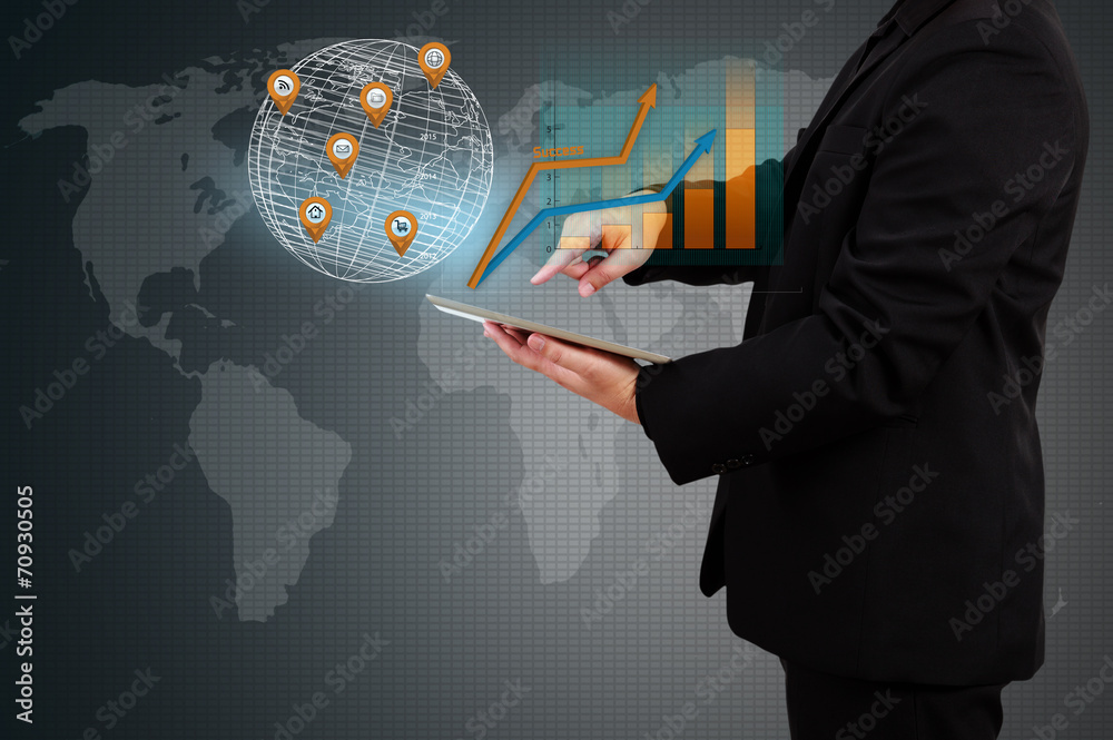 Wall mural businessman holding a tablet showing business graph on virtual s