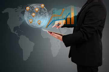 businessman holding a tablet showing business graph on virtual s