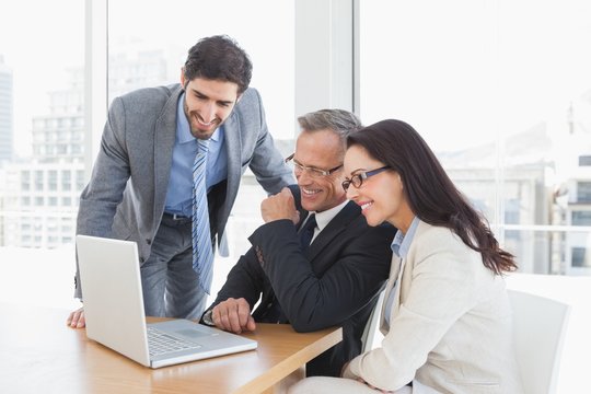 Smiling team enjoying a video