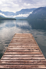 Fototapeta premium Jetty on the misty lake in Alps, Austria