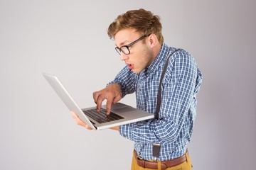 Geeky businessman using his laptop