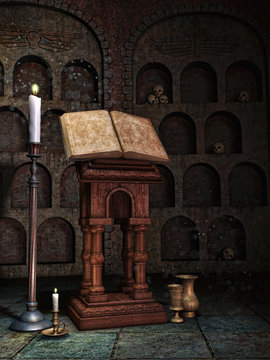 Stara księga i świece w krypcie z czaszkami