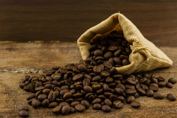 Brown roasted coffee beans in canvas sack.