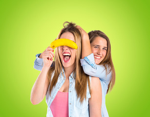 Friends playing with fruits over green background