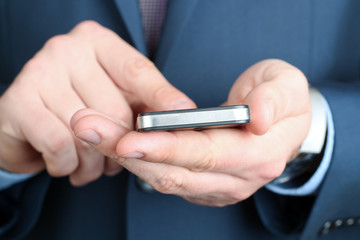 Businessman holding  and using the  mobile  smart  phone