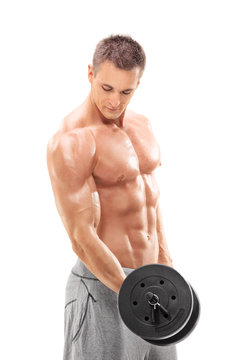 Handsome shirtless man exercising with a barbell