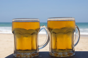 Chilled beer on a sunny day by the beach
