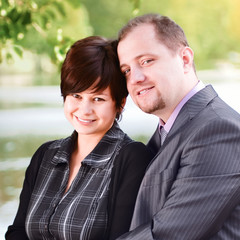 Young couple at a lake in summer park