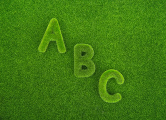 Alphabet letters ABC made from grass with grass background