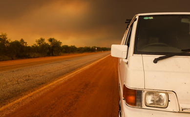 Fototapeta na wymiar Driving under a bush fire in the outback Australia