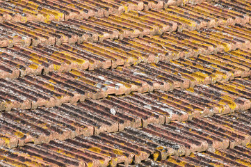 Weathered tiles of old house roof as background