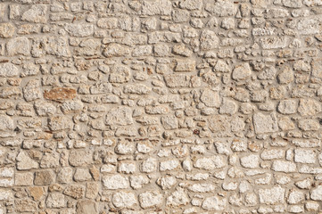 White masonry stone wall of village house as background