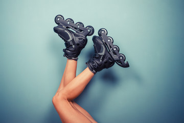 Legs of woman wearing rollerblades - obrazy, fototapety, plakaty