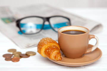 Coffee with croissant on a worktable