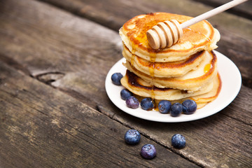 Delicious pancakes with blueberry and honey