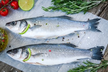 Two raw seabass with lime, cherry tomatoes and rosemary