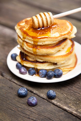 Delicious pancakes with blueberry and honey