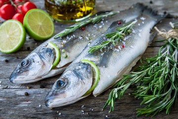 Two raw seabass with lime, cherry tomatoes and rosemary
