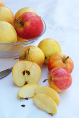 Red apples in white background with knife.