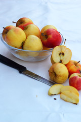 Red apples in white background with knife.