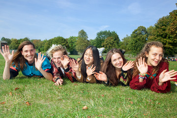 Fototapeta na wymiar Group of young people lying in the park