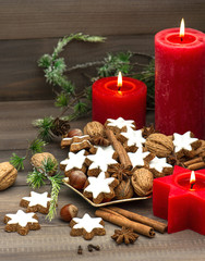 Fototapeta na wymiar cinnamon cookies, nuts and spices with christmas decorations