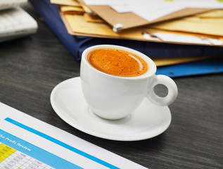 Coffee cup and papers