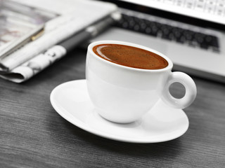 Coffee, newspapers and laptop