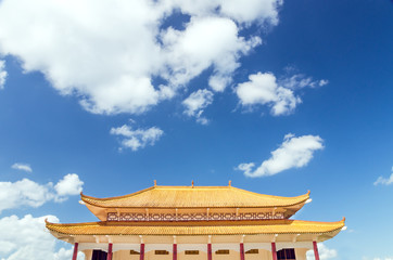 Buddhist temple against a blue sky with dramatic clouds