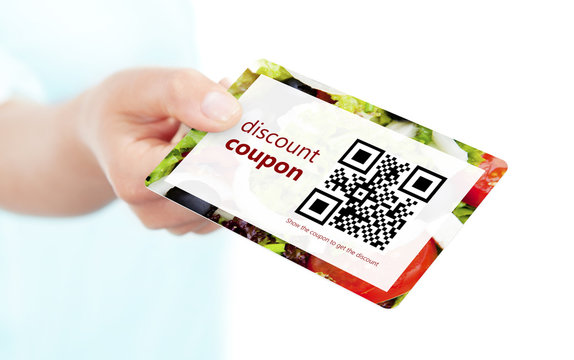 hand holding food discount coupon with qr code isolated over whi