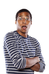 shocked dark-skinned young man with glasses and arms crossed
