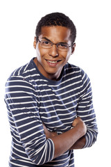 smiling dark-skinned young man with glasses and arms crossed